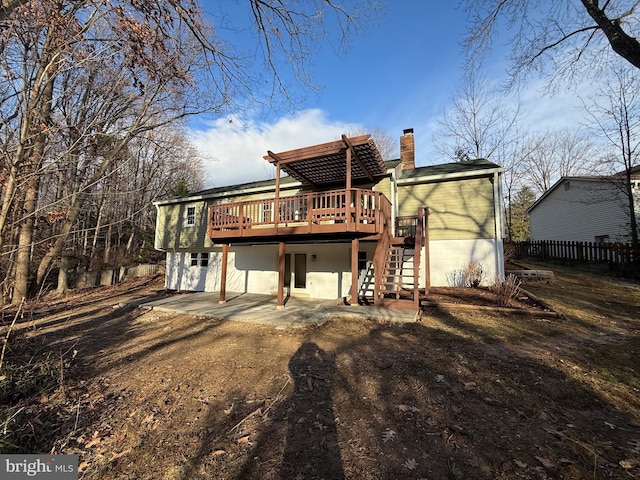 rear view of property featuring a patio and a deck