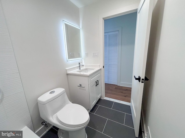 bathroom with tile patterned flooring, vanity, and toilet