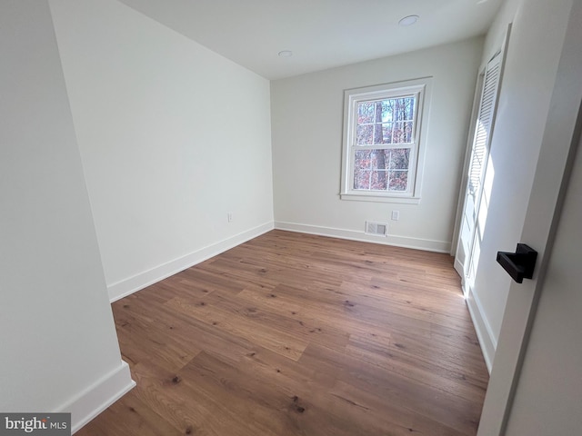 empty room with wood-type flooring