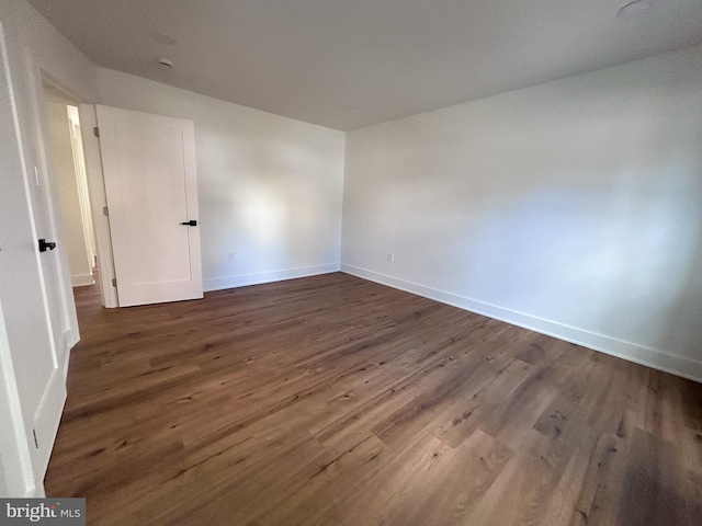 spare room featuring dark hardwood / wood-style flooring