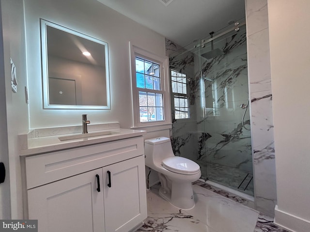 bathroom with vanity, toilet, and a shower with shower door