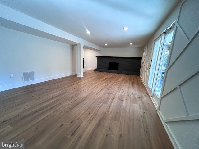 unfurnished living room featuring hardwood / wood-style flooring and a fireplace