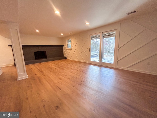 unfurnished living room featuring a fireplace and hardwood / wood-style floors