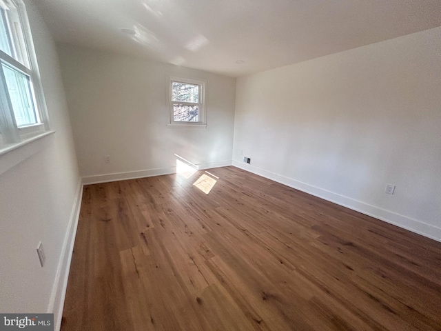 spare room with hardwood / wood-style floors