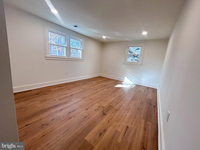 empty room featuring plenty of natural light and light hardwood / wood-style floors