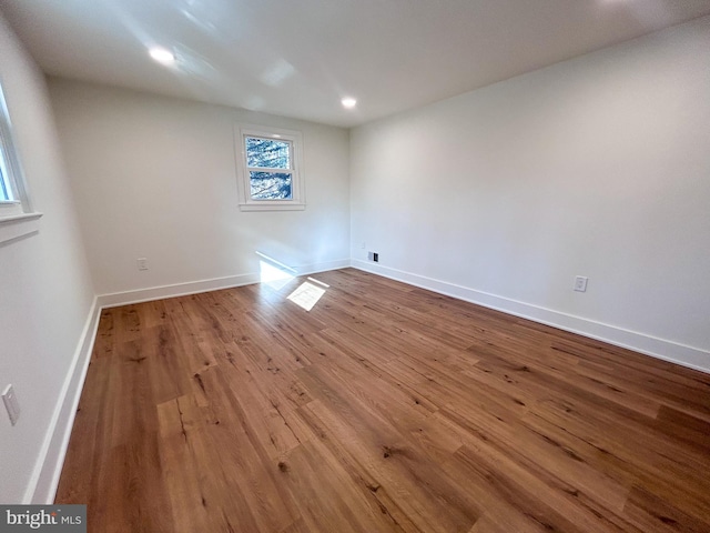 unfurnished room featuring hardwood / wood-style flooring