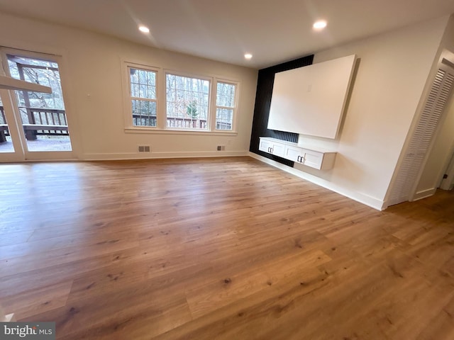 interior space with plenty of natural light and hardwood / wood-style flooring