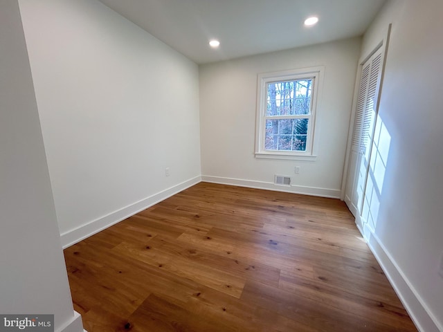 spare room with hardwood / wood-style floors