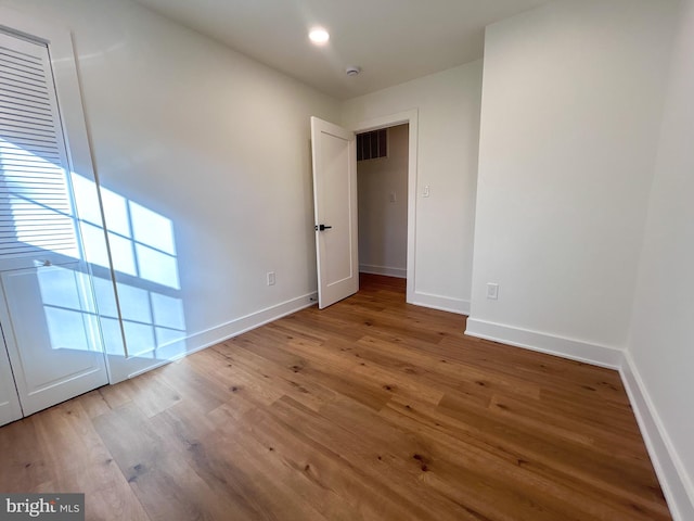 spare room with hardwood / wood-style floors