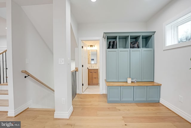 mudroom featuring light wood-type flooring and baseboards