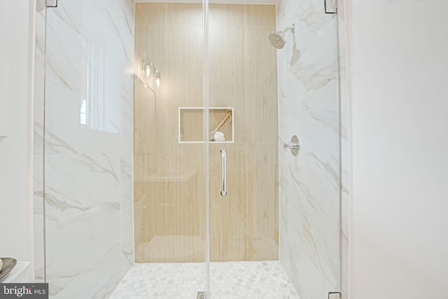 bathroom with a marble finish shower