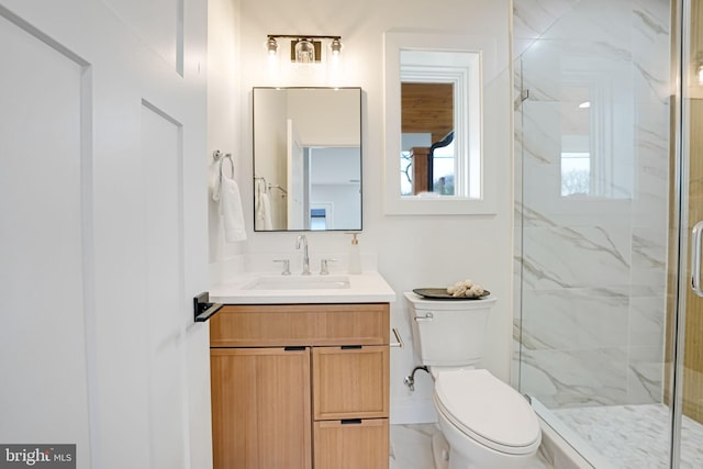 bathroom with a marble finish shower, marble finish floor, vanity, and toilet