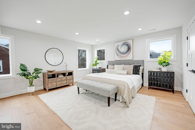 bedroom featuring baseboards, light wood finished floors, visible vents, and recessed lighting