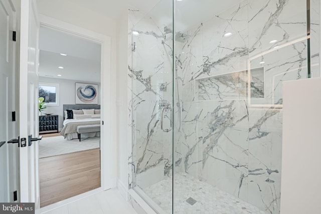 ensuite bathroom with recessed lighting, a marble finish shower, and ensuite bathroom