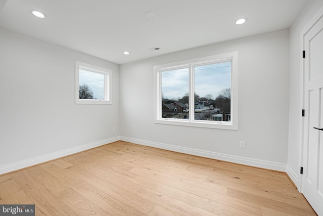 unfurnished room featuring recessed lighting, baseboards, and wood finished floors