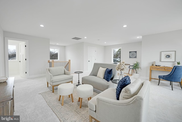 living room featuring a wealth of natural light, recessed lighting, light carpet, and baseboards