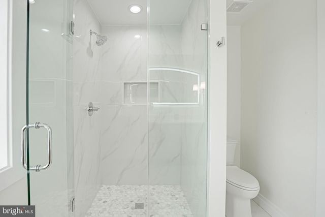 full bathroom featuring toilet, baseboards, a marble finish shower, and visible vents