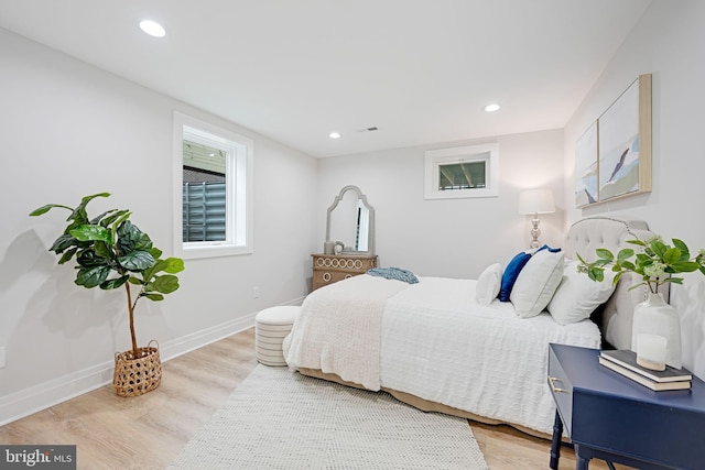 bedroom with recessed lighting, wood finished floors, visible vents, and baseboards