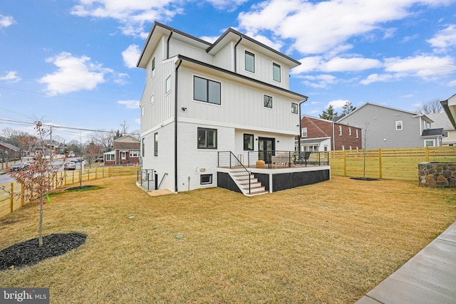 back of house featuring a residential view, a fenced backyard, and a yard