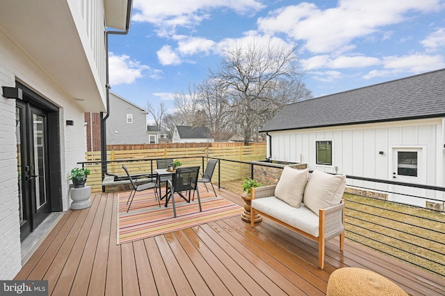 wooden terrace featuring outdoor dining area and outdoor lounge area