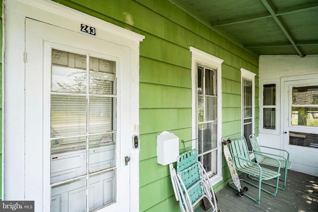 view of exterior entry featuring a porch