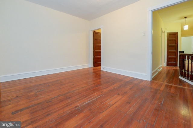 empty room with dark hardwood / wood-style floors