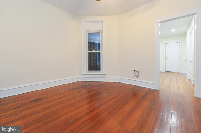 spare room featuring wood-type flooring