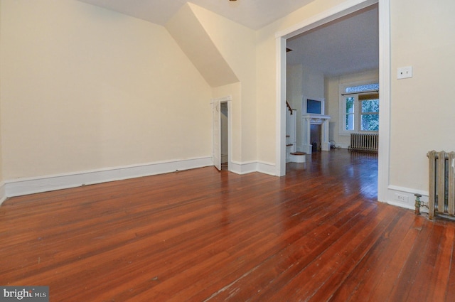 interior space featuring dark hardwood / wood-style flooring and radiator heating unit