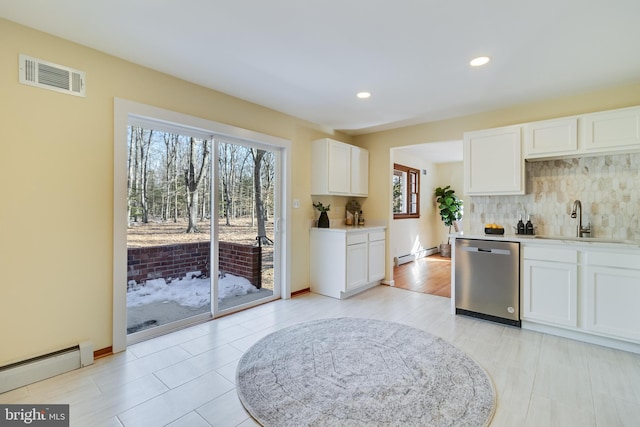 kitchen with white cabinetry, dishwasher, a baseboard heating unit, and sink