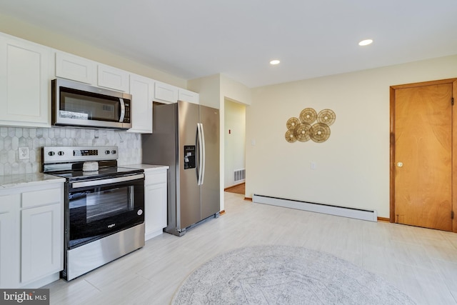 kitchen with white cabinetry, a baseboard radiator, appliances with stainless steel finishes, and tasteful backsplash