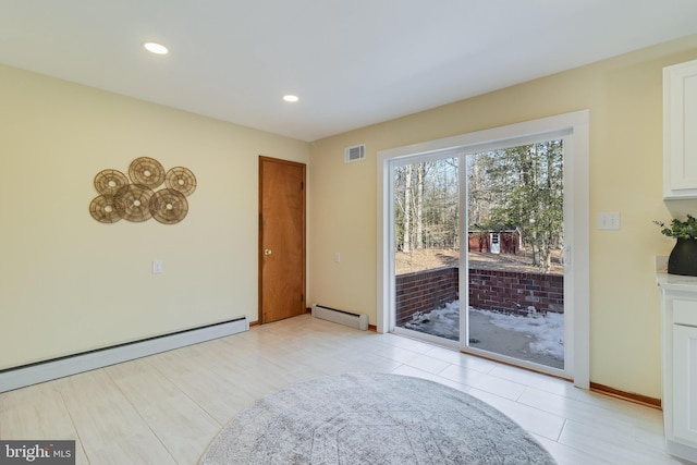 interior space with a baseboard heating unit and light tile patterned flooring