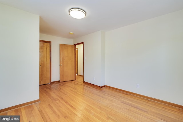 spare room featuring light wood-type flooring