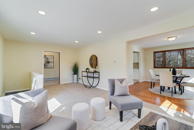 living room featuring a baseboard radiator and light hardwood / wood-style floors