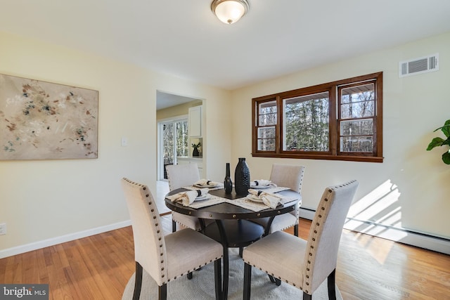 dining space featuring light wood-type flooring