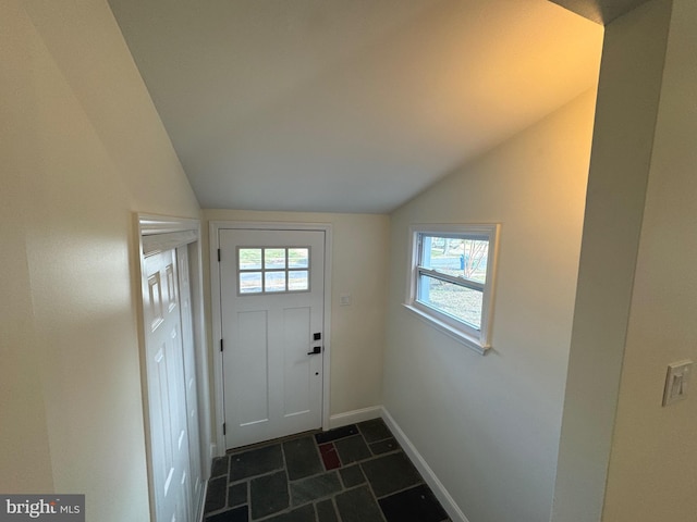 doorway to outside featuring lofted ceiling