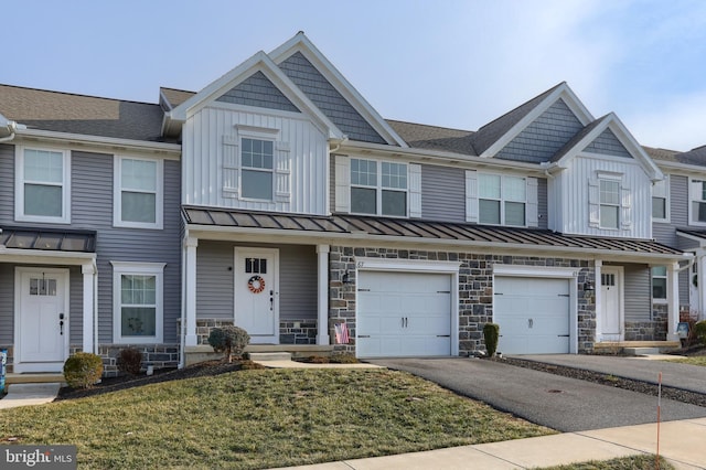 multi unit property with a front yard and a garage