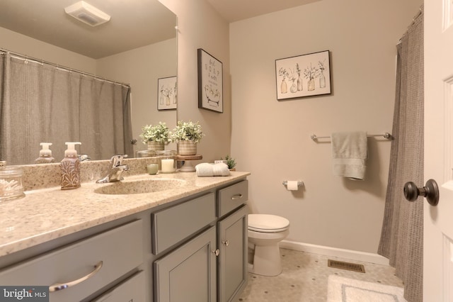 bathroom featuring vanity and toilet