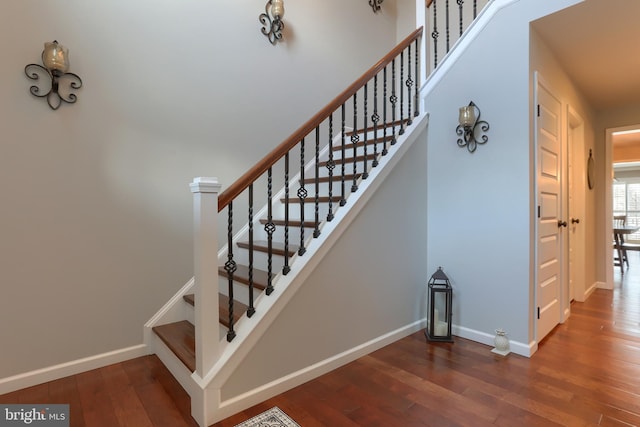 stairway with hardwood / wood-style flooring