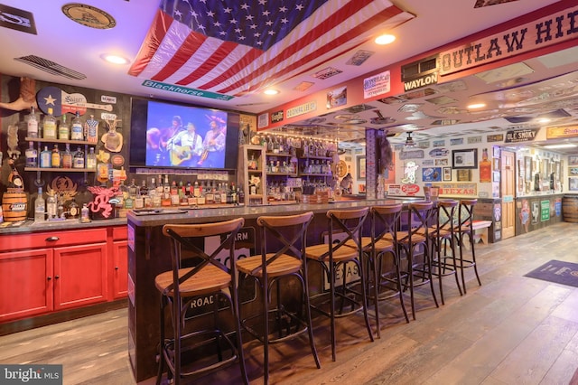 bar featuring light hardwood / wood-style floors