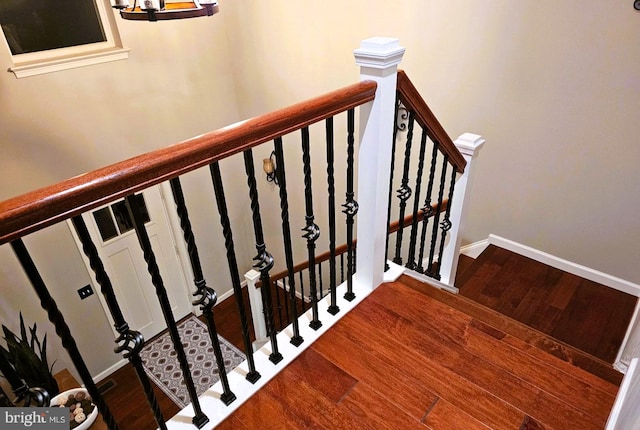 staircase featuring hardwood / wood-style flooring