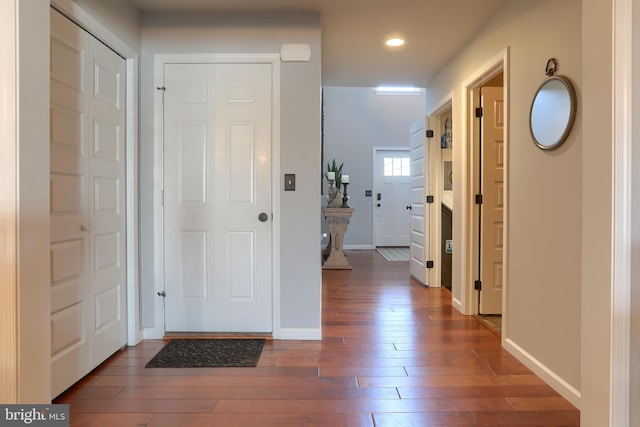 hall with dark hardwood / wood-style flooring