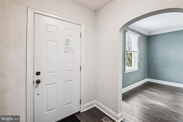 foyer with dark hardwood / wood-style flooring and crown molding