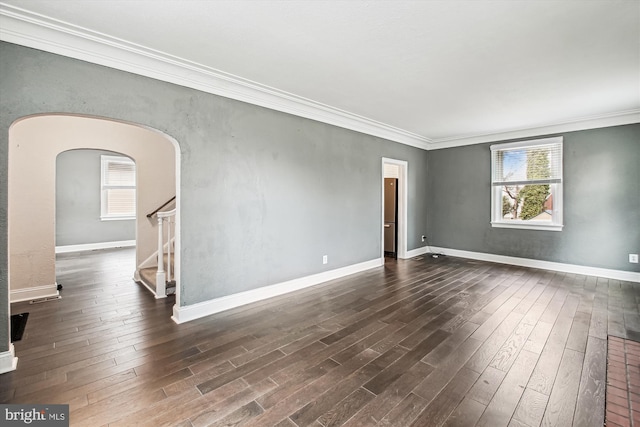 spare room featuring dark hardwood / wood-style flooring and plenty of natural light