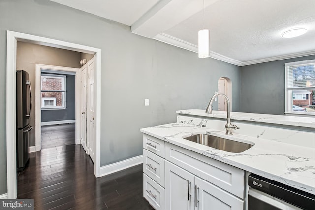 kitchen with appliances with stainless steel finishes, sink, hanging light fixtures, and white cabinets