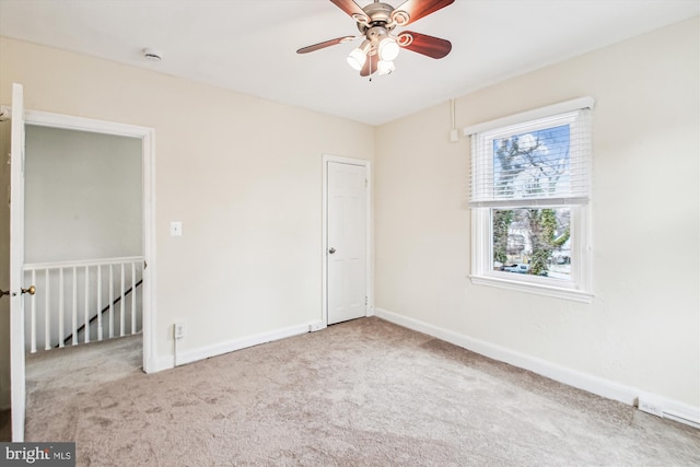 unfurnished room featuring ceiling fan and light carpet