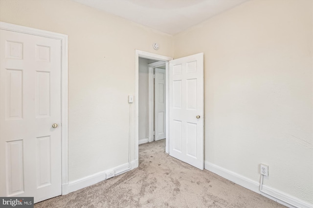 unfurnished bedroom with light colored carpet