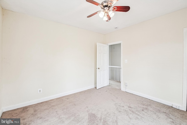 empty room featuring light carpet and ceiling fan