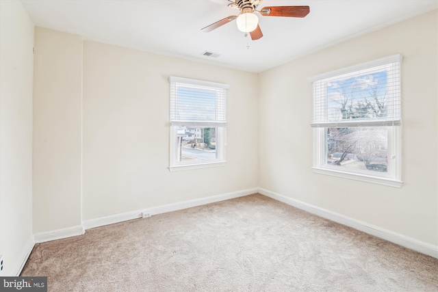 carpeted spare room with ceiling fan