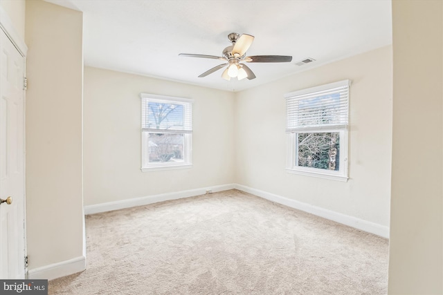 carpeted spare room with ceiling fan