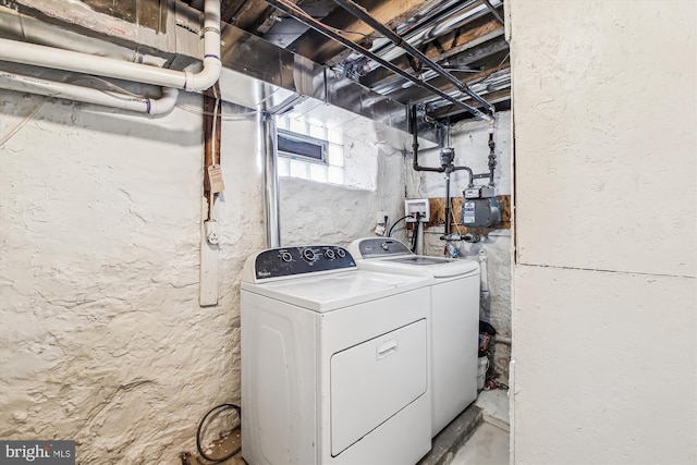 clothes washing area with separate washer and dryer